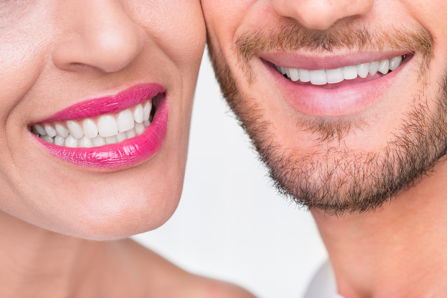 Zwei lächelnde Personen mit weißen Zähnen